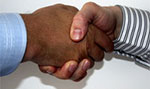 Zwei Menschen geben sich die Hand