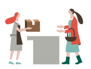 Eine Verkäuferin übergibt der Abholerin das Paket.